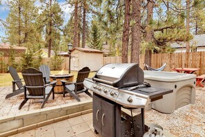An outdoor patio with a grill, Adirondack chairs, and a hot tub. - Beary Cozy Cabin #2315 (Big Bear Lake)