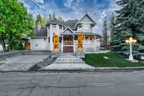 A two-story house with a porch, a front yard, and a driveway. - Bears Palace Chalet #2008 (Big Bear Lake)