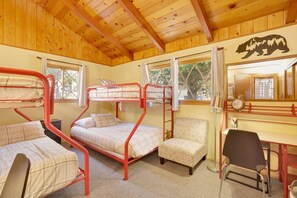 A room with bunk beds, a desk, a chair, and a mirror. - Sunny Bear Cabin #1970 (Big Bear Lake)