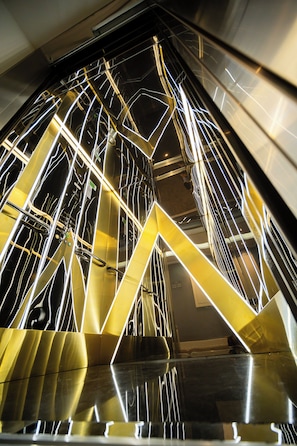 A modern interior with geometric metal structures and reflective surfaces. - Alion Hotel Izmir (Izmir)