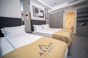 A hotel room with two beds, a wardrobe, and a bathroom visible through an open door. - Alion Hotel Izmir (Izmir)
