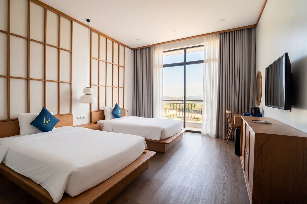 A hotel room with two beds, a TV, and a balcony with a view.