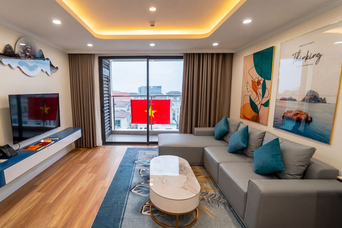 A modern living room with a sofa, coffee table, and a flat-screen TV.