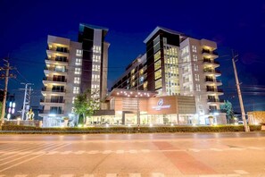 A multi-story hotel with a modern design, featuring balconies and a prominent entrance. - Bangkok Eastern Hotel (Bang Bo)