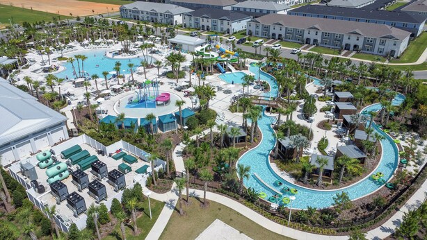 An aerial view of a resort with multiple swimming pools, palm trees, and a variety of recreational facilities. - Breezy Palms|Spectacular NEW Villa|NEW WOW Resort (Clermont)