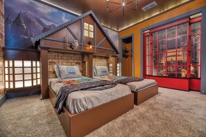 Une chambre à coucher avec un grand lit, une porte rouge et une fresque représentant un château.