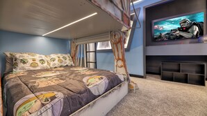 A bedroom with a bunk bed, Star Wars-themed bedding, a television on the wall, and a rustic ceiling. - Breezy Palms|Spectacular NEW Villa|NEW WOW Resort (Clermont)