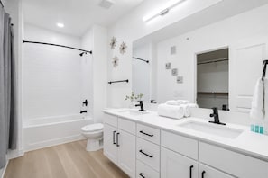 A modern bathroom with a shower, toilet, sink, and vanity. - Modern Apt I Prime Location & Workspace (Sherman)