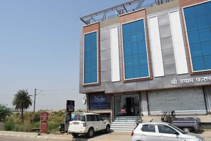 A hotel with a modern facade, large windows, and a signboard indicating it is a hotel. - Hotel Highway Crown (Kanpur)