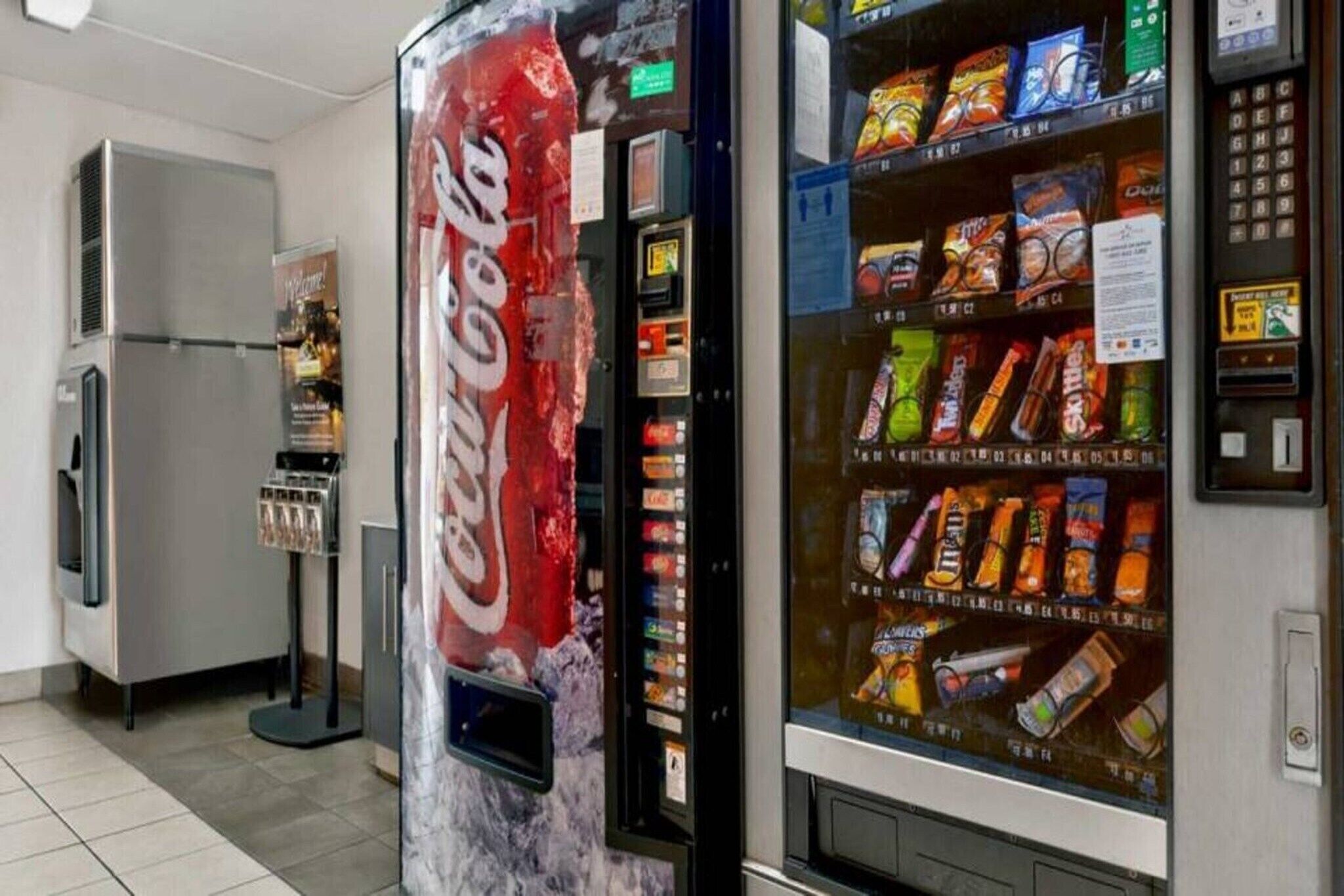 A vending machine with various snacks and a Coca-Cola machine.