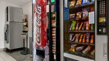A vending machine with various snacks and a Coca-Cola machine.