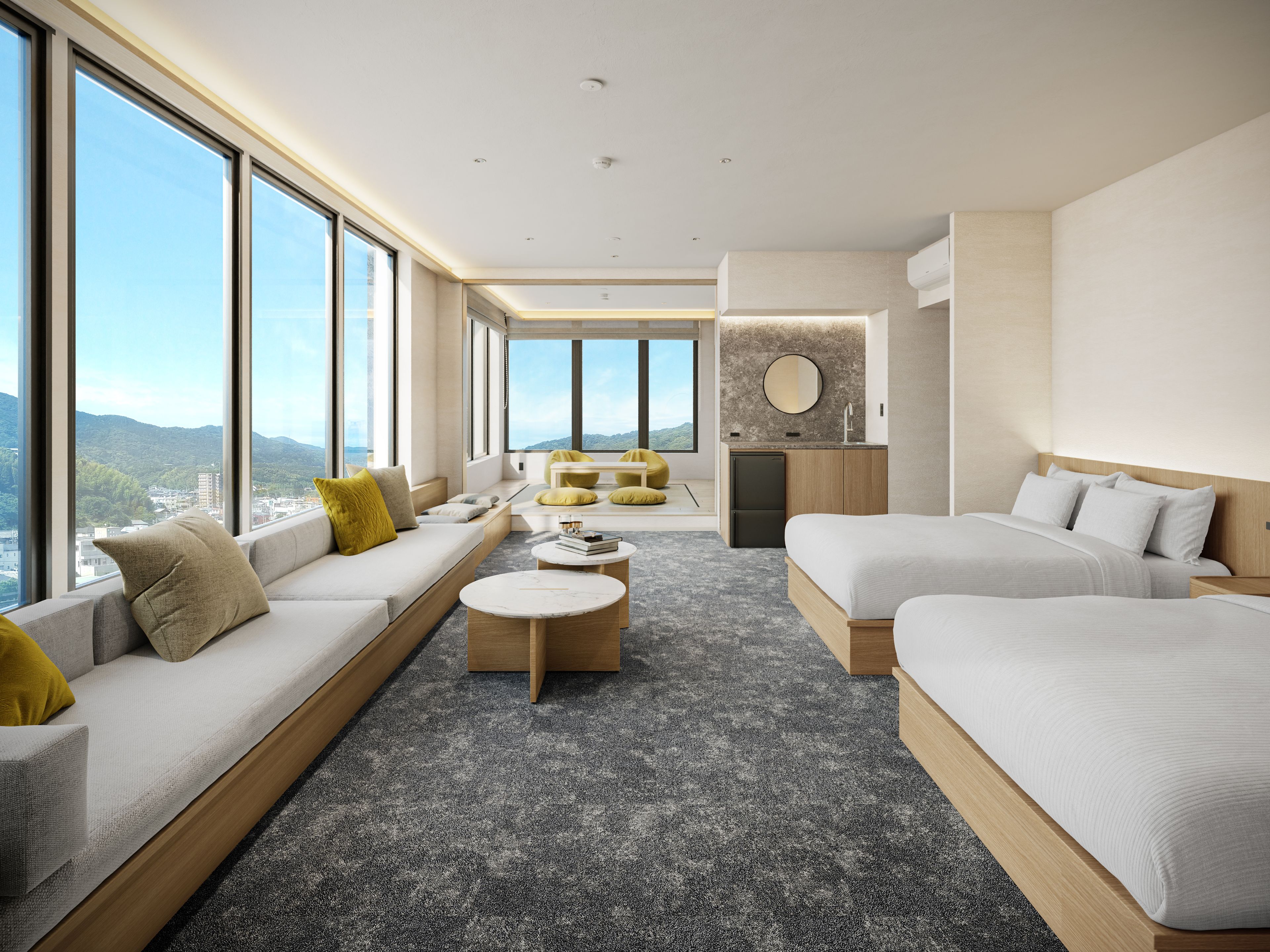 A modern hotel room with a large window, a sofa, a bed, a small kitchen area, and a view of the city.
