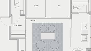 A hotel room layout with two beds, a bathroom, a living area with a kitchen, and an entrance.