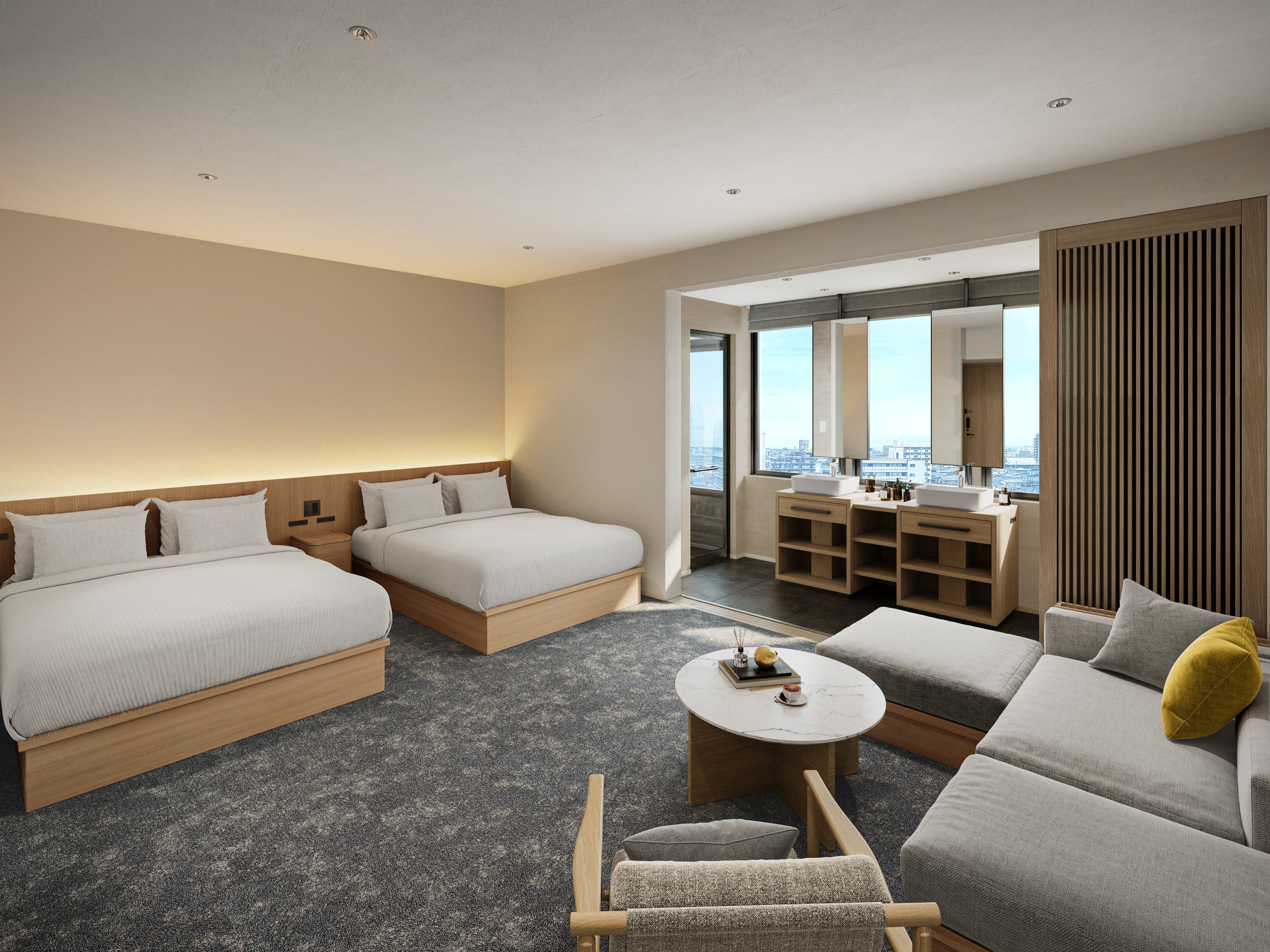 Habitación de hotel con dos camas, un sofá, una mesita y un baño con tocador y espejo.
