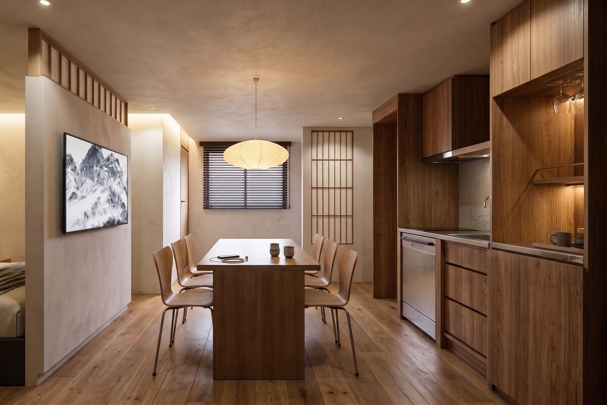 Un interno moderno con zona pranzo, cucina e un letto vista.