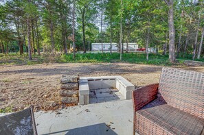 A concrete structure with a brick bench in a wooded area. - 7 Mi to Lucas Oil Speedway! Home w/ Patio & Yard (Wheatland)