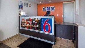 A reception desk with a sign that reads 'We'll leave the light on for you.' - Spacious King Bed|Free Wifi&Parking (CONNELLY SPRINGS)
