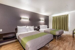 A hotel room with two beds, a wooden floor, and a window with curtains. - 2 Full Beds | Suite, Non-Smoking, Kitchen (Orange)