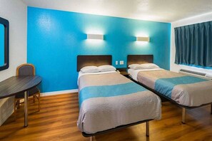 A room with two beds, a desk, and a chair. - 2 FULL BEDS | SMOKING (Grand Prairie)
