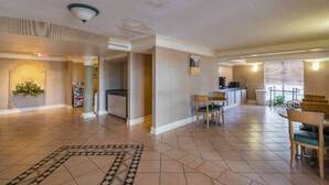 A spacious living area with a kitchen, dining area, and a visible staircase leading to an upper level. - 2 FULL BEDS | SMOKING (Grand Prairie)