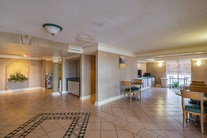 A spacious living area with a kitchen, dining area, and a visible staircase leading to an upper level. - 2 FULL BEDS | SMOKING (Grand Prairie)