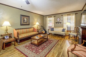 A traditional living room with a sofa, armchairs, a coffee table, and a television. - Centrally Located Nature Escape in Trenton (Trenton)