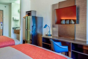 A hotel room with two beds, a desk, a chair, a TV, and a minibar. - 2 Queen Beds | Non-Smoking, Mini Fridge (Percival)