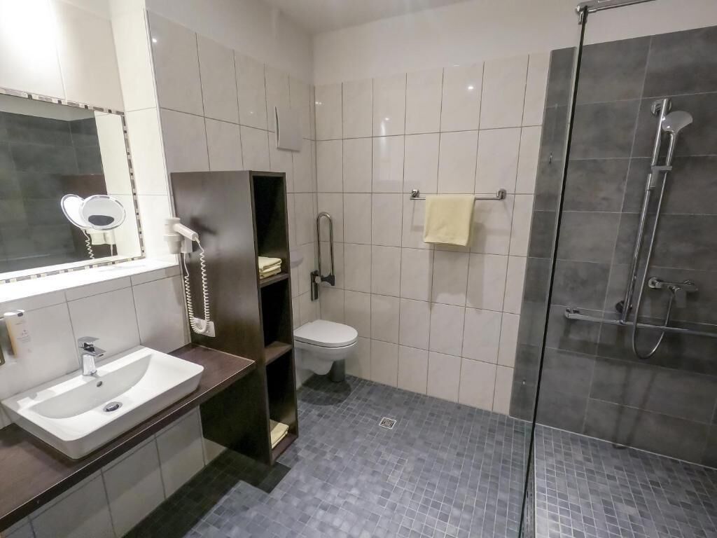 Un baño con lavabo, inodoro y zona de ducha.