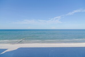 A beach with a clear sky and calm sea. - Unit w/ Stunning Gulf Views! Steps to Pool & Beach (Madeira Beach)