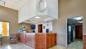A reception area with a wooden counter, a clock, and a television. - 2 Queen Beds | Non-Smoking, Micfridge (Effingham)