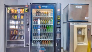 Three vending machines with various items, including snacks and beverages. - 2 Queen Beds | Non-Smoking, Micfridge (Effingham)