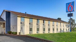 A motel with a row of rooms, a parking lot, and a grassy area. - 2 Queen Beds | Non-Smoking, Micfridge (Silver City NM)