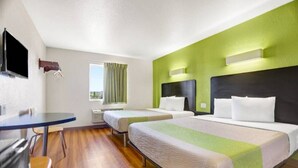 A hotel room with two beds, a desk, and a chair. - 2 Queen Beds | Non-Smoking, Micfridge (Silver City NM)