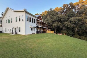 A two-story house with a covered porch and a well-maintained lawn.