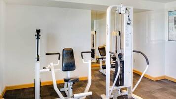 A gym with exercise equipment including a leg press machine and a chest press machine.