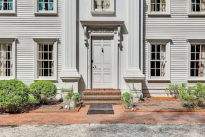 A two-story building with a symmetrical facade, a central entrance with a double door, and a brick pathway leading to the entrance. - 3 Mi to Dtwn! Grand Goldsboro Getaway (Goldsboro)