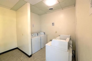 A laundry room with two washing machines and a dryer. - 1 King Bed | Non-Smoking, Kitchen, Sofa (Longview)