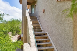 A concrete staircase leading to a building entrance with a door and window. - Pool & Hot Tub Access! Family Condo in Oro Valley (Oro Valley)