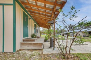 A covered outdoor area with a wooden deck, a trash can, and a small tree. - 5-Unit Retreat Near World Equestrian Center & HITS (Morriston)