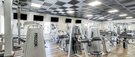 A gym with various exercise machines, including weight benches and cardio equipment.