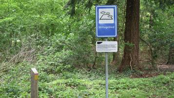 A signpost with a blue background and white text, indicating a stilted area.