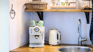 A kitchen with a toaster, a kettle, and a sink.