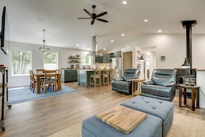 A spacious living area with a dining table, chairs, a sofa, and a recliner. - Newly Built Wooded Getaway in Grand Junction (Grand Junction)