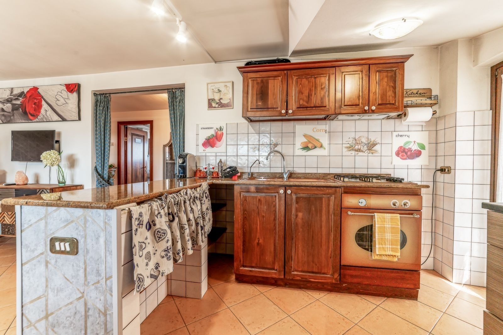 A kitchen with wooden cabinets, a built-in oven, and a tiled backsplash.