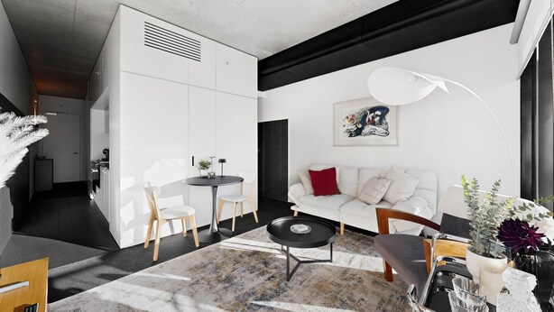 Ein modernes Wohnzimmer mit einem weißen Sofa, einem runden Couchtisch und einem Essbereich mit weißem Tisch und Stühlen.