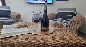 A wicker table with a book, a wine bottle, glasses, and candles. - Villa in Donnalucata with 4 bedrooms sleeps 10 (Donnalucata)