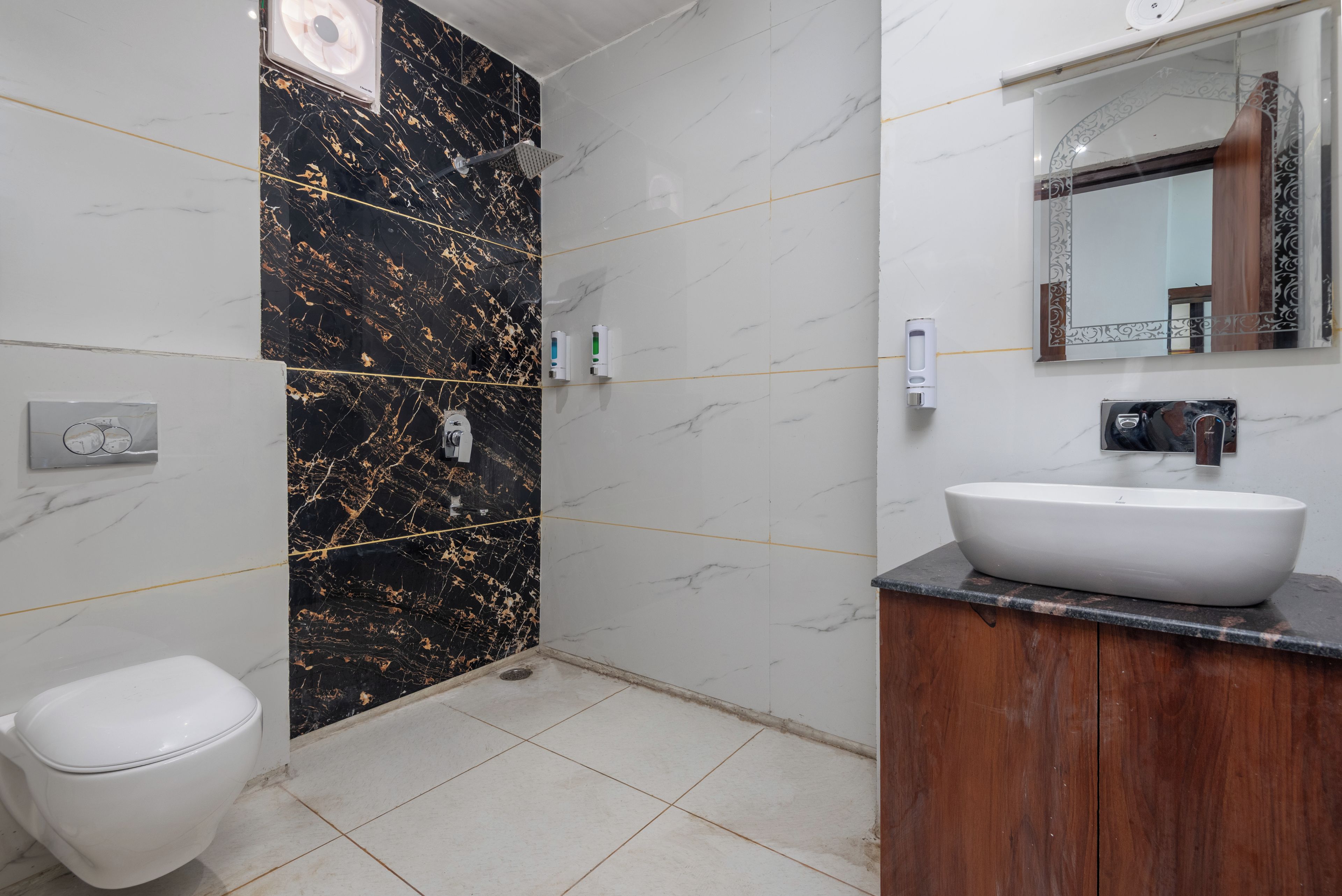 A bathroom with a toilet, a sink, and a shower area.