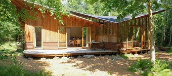 Hand-built timber and clay cottage by Bøtøskoven
