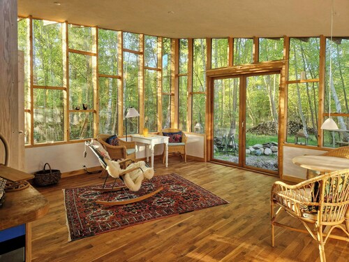 Hand-built timber and clay cottage by Bøtøskoven