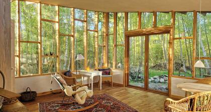 Hand-built timber and clay cottage by Bøtøskoven